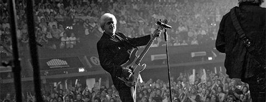 Image of Merrill Osmond playing guitar in concert